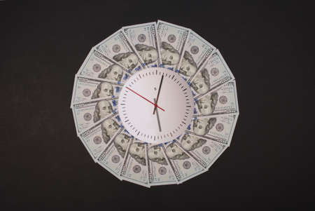 Concept of clock and dollar. Clock on mandala kaleidoscope from money. Abstract money background raster pattern repeat mandala circle. On black background.の写真素材