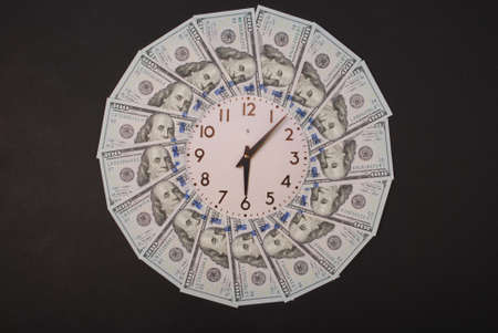 Concept of clock and dollar. Clock on mandala kaleidoscope from money. Abstract money background raster pattern repeat mandala circle. On black background.の写真素材