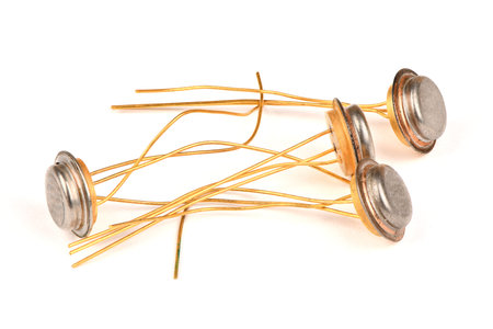 Old radio component, the semiconductor transistor with the contacts covered with gold on a white...