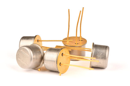 Old radio component, the semiconductor transistor with the contacts covered with gold on a white...