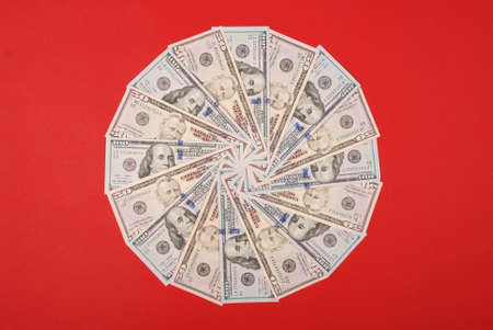 Mandala kaleidoscope from money. Abstract money background raster pattern repeat mandala circle. On red background.の写真素材