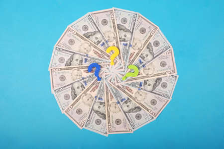 Question mark on kaleidoscope from money. Abstract money background raster pattern repeat circle on green background. High resolution photo.の写真素材