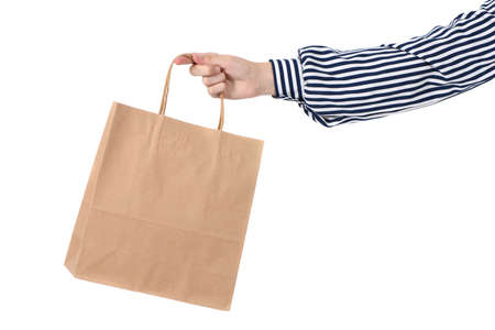 Child hand holding paper shopping bags isolated on white background. Holiday present, shopping. High resolution photo. Full depth of field.の写真素材