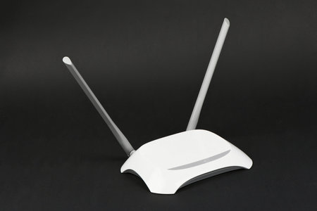 White WIFI router with two antennas isolated on black background, Clipping path inside. High...