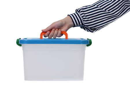 Child hand holding plastic container isolated on white background. High resolution photo. Full depth...