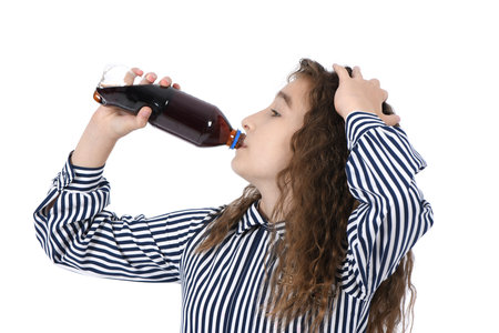 Child drinking Cola from bottle. On white background. High resolution photo. Full depth of field.の写真素材
