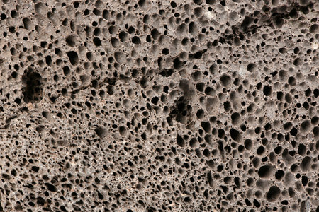 Surface of brown pumice - closeup. Pumice brown sponge texture for body wash. High resolution photo. Full depth of field.の写真素材