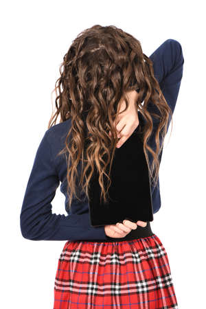 Portrait of pretty curly young girl smile and showing tablet pc isolated on white background. High resolution photo. Full depth of field.の写真素材