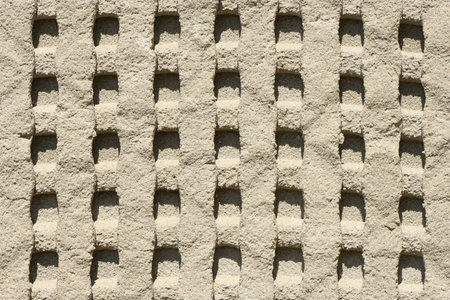 Background of old tile adhesive on wall being repaired. Abstract pattern of notched trowel. High resolution photo. Full depth of field (DOF).の写真素材