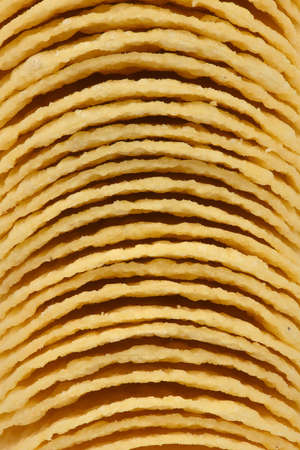 Background of tasty crispy potato chips. High resolution photo. Full depth of field.の写真素材