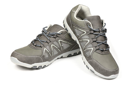 Pair gray modern sneakers isolated on a white background. View from the front. High resolution...