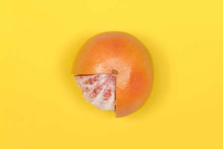 Grapefruit isolated on yellow background. High resolution photo. Full depth of field.の写真素材