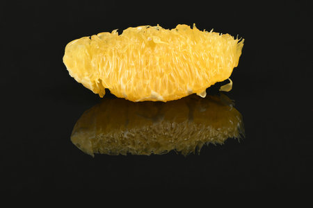 Perfectly retouched orange isolated on acrylic black background. High resolution photo. Full depth...