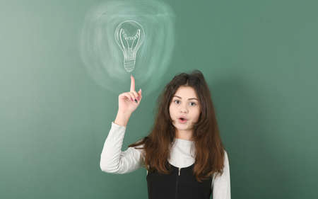 Pre-adolescent girl ponders her next step. Concept risk and chance of victory. Dice drawn in chalk. High resolution photo. Full depth of field.の写真素材