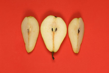 Pears isolated on red background. Pears macro studio photo. High resolution photo. Full depth of field.の写真素材
