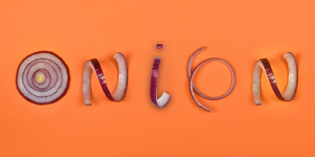 Onion inscription written in sliced red onions isolated on orange background. High resolution photo. Full depth of field.の写真素材