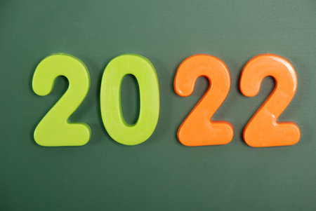 2022 year written in bright plastic magnetic letters stuck on a magnetic board