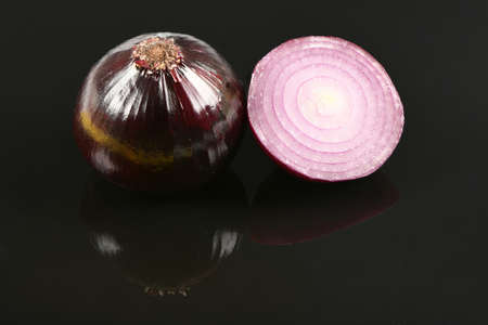Red onion bulb isolated on acrylic black background. High resolution photo. Full depth of field.の写真素材