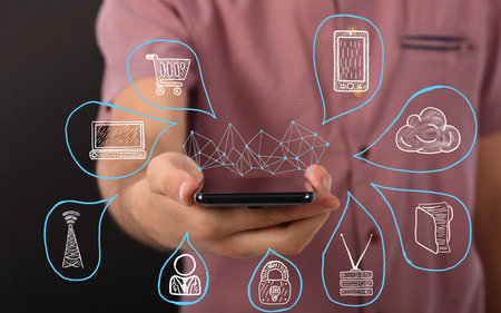 Portrait of handsome businessman holding smartphone with connections system global data exchanges...