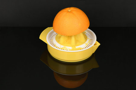Perfectly retouched orange isolated on acrylic black background. High resolution photo. Full depth...