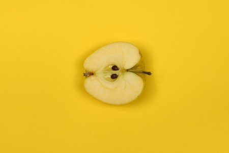 Yellow apple isolated on yellow. High resolution photo. Full depth of field.の写真素材