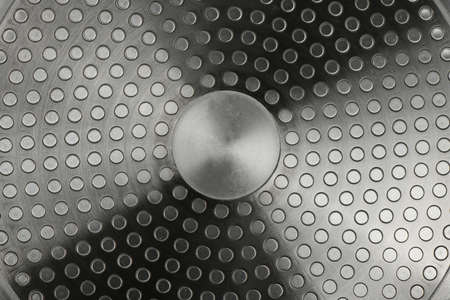 Induction frying pan bottom. metal texture. Extreme close-up. High resolution photo. Full depth of field.の写真素材