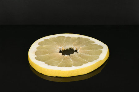 Pomelo isolated on acrylic black background. High resolution photo. Full depth of field.