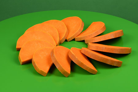 Ripe sliced Butternut squash (Cucurbita moschata). Vegetable on geen background. High resolution photo. Full depth of field.の写真素材