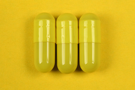 Pharmaceutical pills, medicine for people's health to heal diseases. Yellow tablets on yellow background. High resolution photo. Full depth of field.の写真素材
