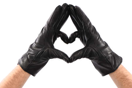 Man wearing black leather glove on white background, closeup, heart sign, Love. side view. High resolution photo. Full depth of field.の写真素材