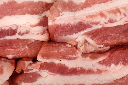 Fresh pork sliced small portions. Raw bacon background. High resolution photo. Full depth of field.の写真素材