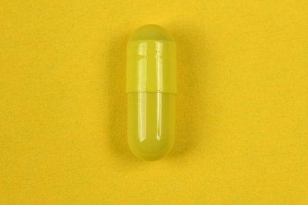 Pharmaceutical pills, medicine for people's health to heal diseases. Yellow tablets on yellow background. High resolution photo. Full depth of field.の写真素材