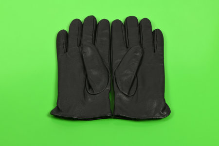 Casual leather gloves isolated on green background. High resolution photo. Full depth of field.の写真素材
