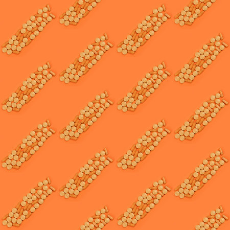 Seamless pattern. Pharmaceutical tablets, medicine for people's health to heal diseases. Orange tablets on orange background. High resolution pattern. Full depth of field.の写真素材