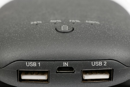 Powerbank new, powerful dark color with two usb inputs on a white background. side view. High resolution photo. Full depth of field.の写真素材