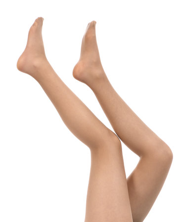 Legs of beautiful young woman in beige tights isolated on a white background. High resolution photo. Full depth of field.の写真素材