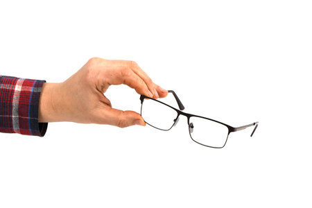 Hand holding plastic black glasses, isolated on white background. High resolution photo. Full depth of field.の写真素材