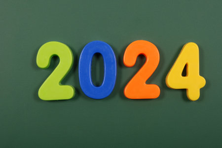 2024 year written in bright plastic magnetic letters stuck on a magnetic boardの写真素材