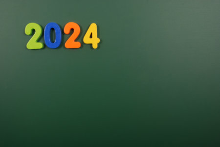 2024 year written in bright plastic magnetic letters stuck on a magnetic boardの写真素材