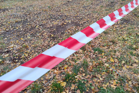 Red and white lines of barrier fencing tape. Fencing red and white tape, which prohibits movement. Warning tape.の写真素材