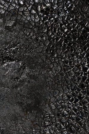 Texture of burnt organic matter. Carbon texture background of black glare color.の写真素材