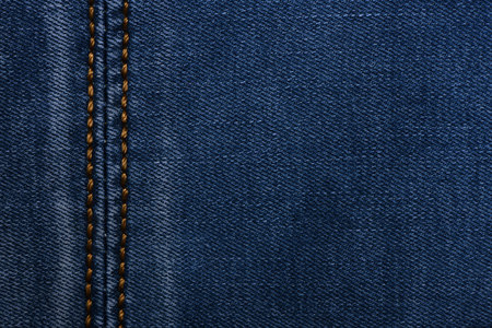 Denim fabric with yellow thread seams, denim jacket, denim pants, for background or fabric sample...