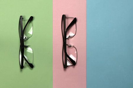 Pair of reading glasses isolated on three colored background. Fashion spectacles for man and woman. High resolution photo. Full depth of field.の写真素材