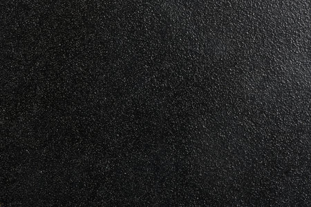 Close up of black textured plastic. Black background.の写真素材