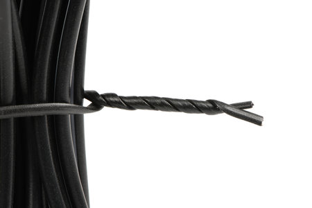 Black wires. Wires are strapped with a black plastic-coated wire tie isolated on white background. High resolution photo. Full depth of field.の写真素材