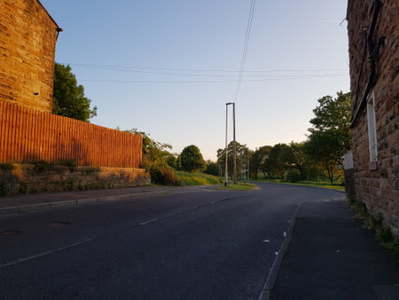 View of a rural road with a fence in the evening light.の写真素材