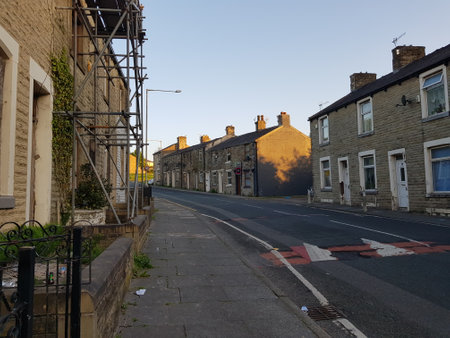 A view of a street in town on a sunny summer evening as the sun setsの写真素材