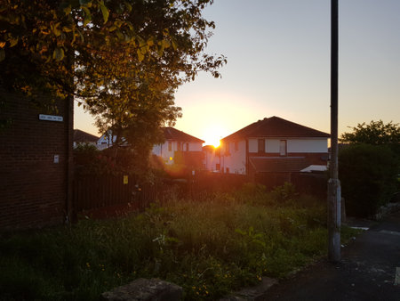 Sunset through the houses on a beautiful summer eveningの写真素材