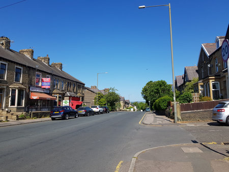 Street view of the main road to the village under a beautiful blue sky in the morning. Scenic rural...
