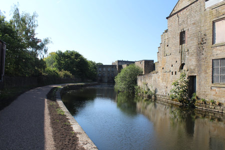 A view the canal as it passes through an older, industrial section of town on a beautiful summer...